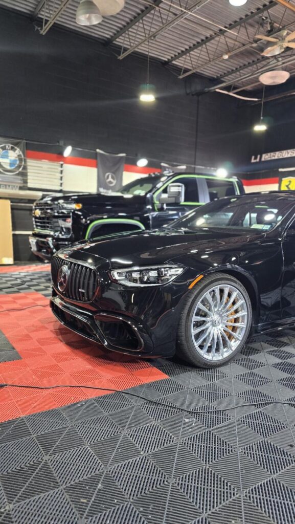 Glossy black Mercedes AMG sedan in a detailing shop | ppf in Long Island | Li Car Guys